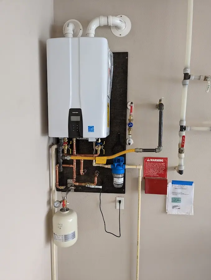 Professional plumber installing copper piping in a Mount Ephraim home